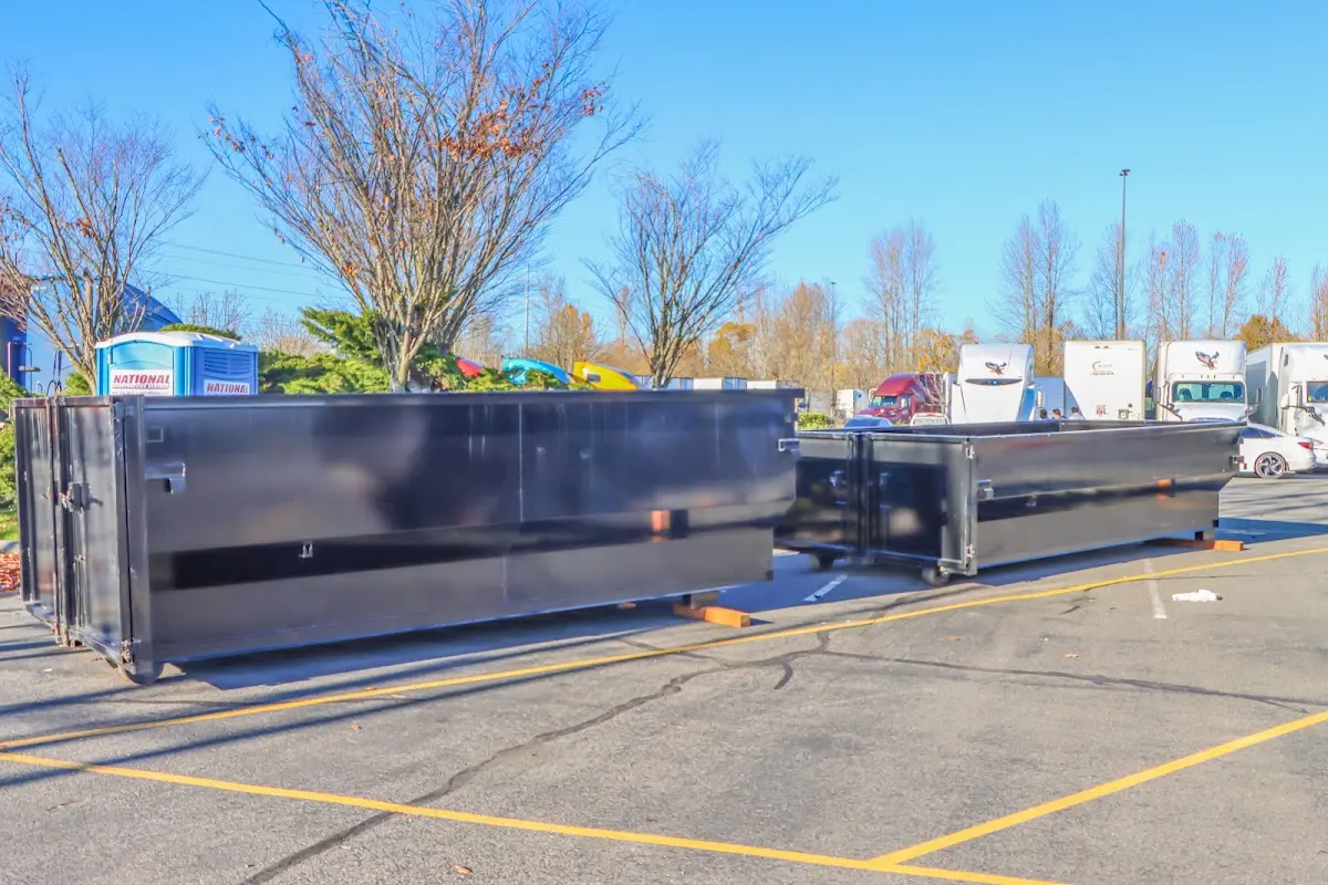 Professional dumpster rental service with roll-off container on residential driveway in Colton
